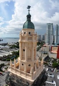 Historic tower with cityscape and ocean view.