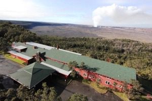 Aerial view of building near volcanic landscape.