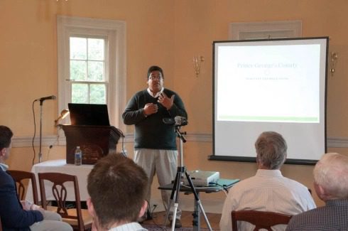 Person giving presentation to small audience.