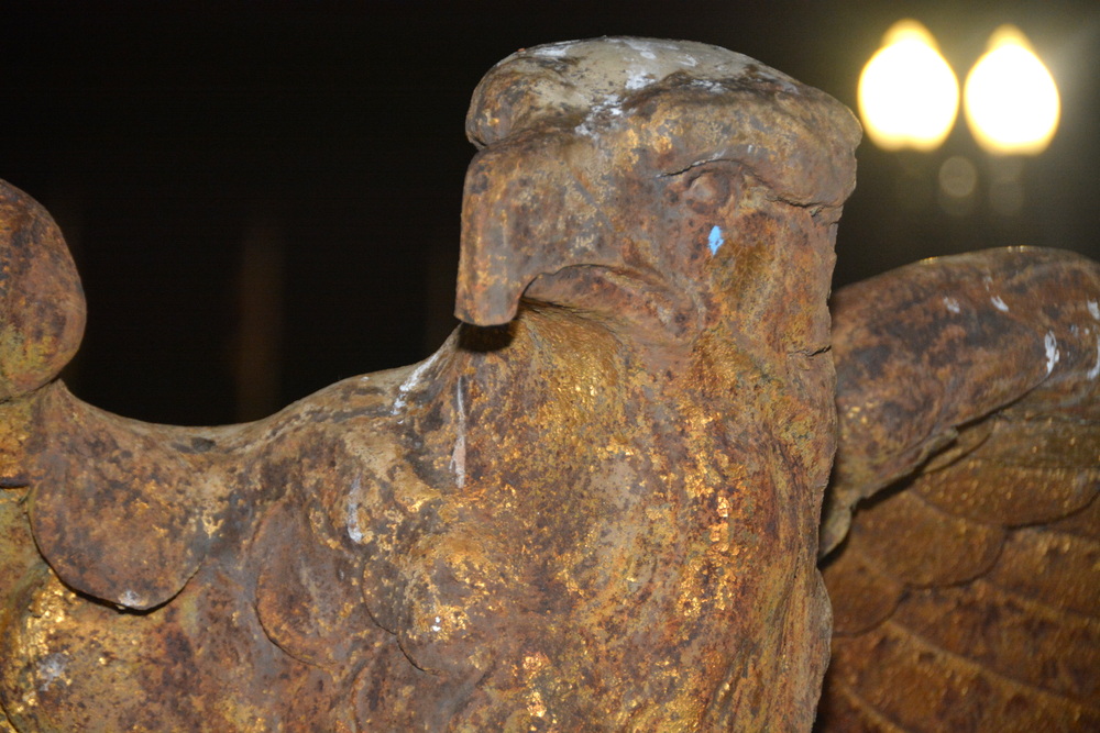 Close-up of a rusted metal figure with a helmet.